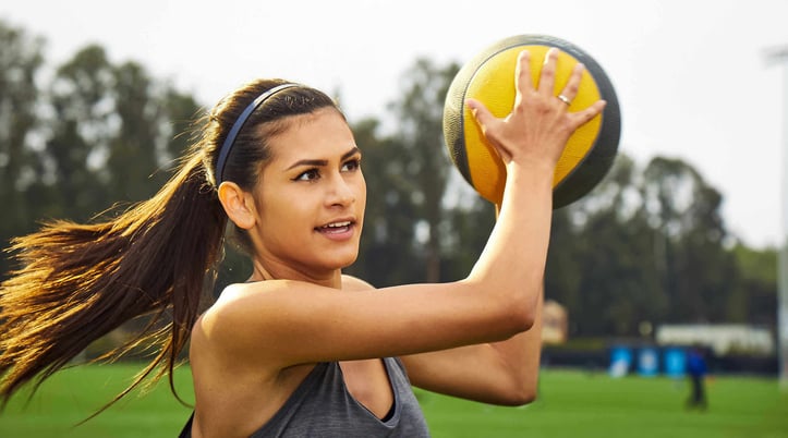 Woman holding up a medicine ball