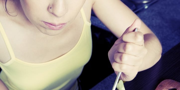 A woman holding a utensil 