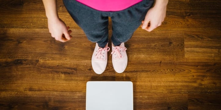 someone standing in front of weight scale