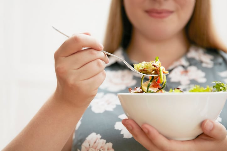 Woman getting ready to eat a salad
