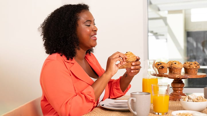 Woman eating muffin