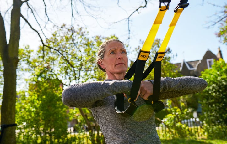 Woman holding on TRX bands