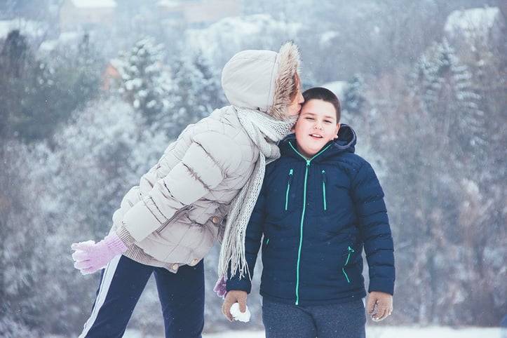 Mother and child outdoors in snow