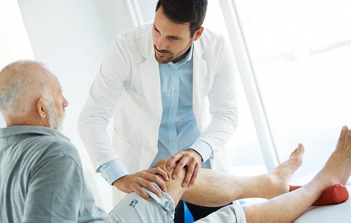 man treating a client with arthritis