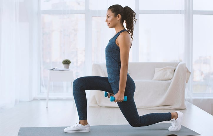 woman doing a lunge at home