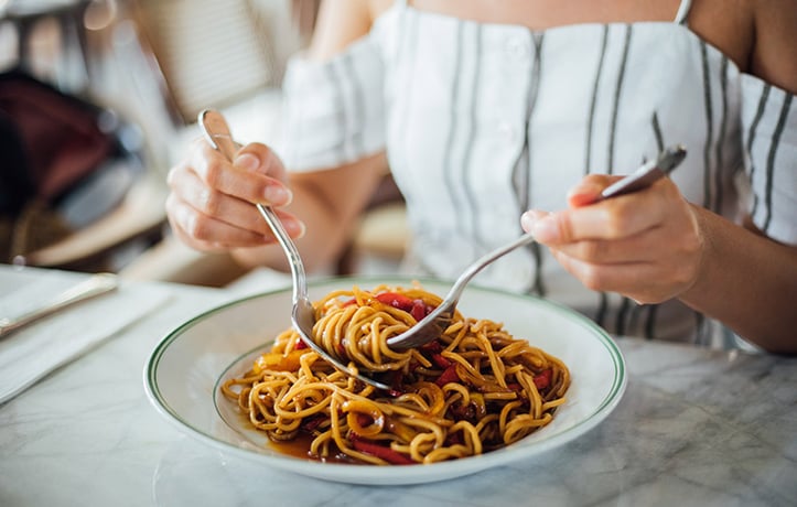 woman eating a plate of spaghetti