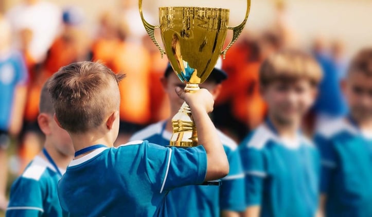 a child holding a trophy