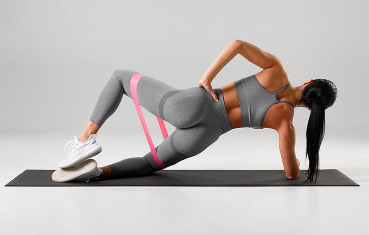 woman doing a clamshell workout
