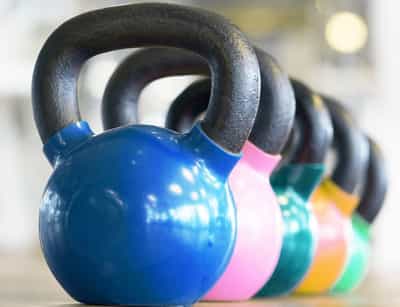 kettlebells lined up in a gym