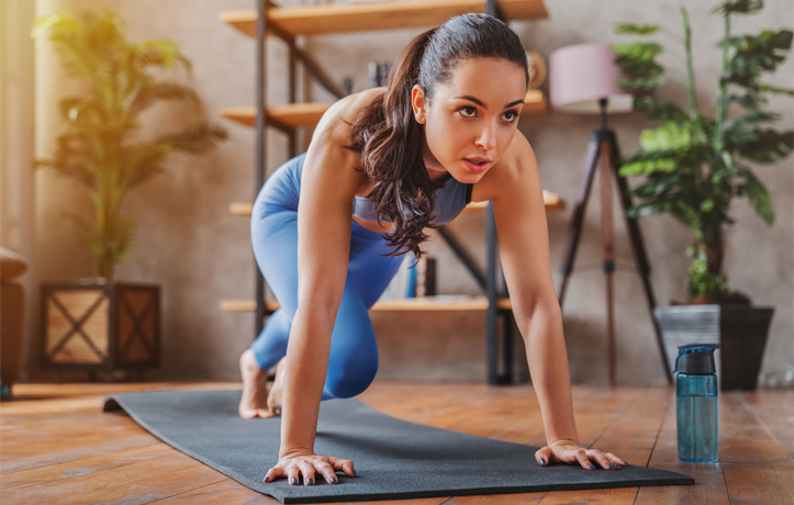 A woman doing mountain climbers workout