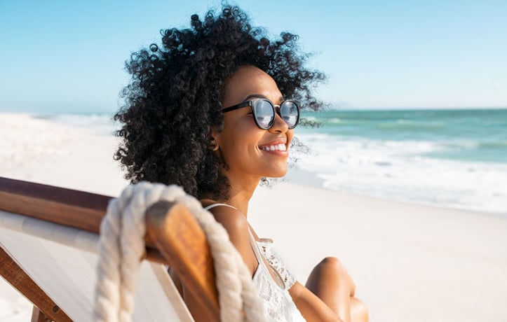 A Woman Smiling on the Beach