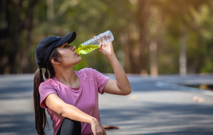 woman drinking an electrolyte beverage