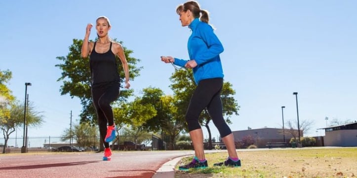 female trainer assisting female runner