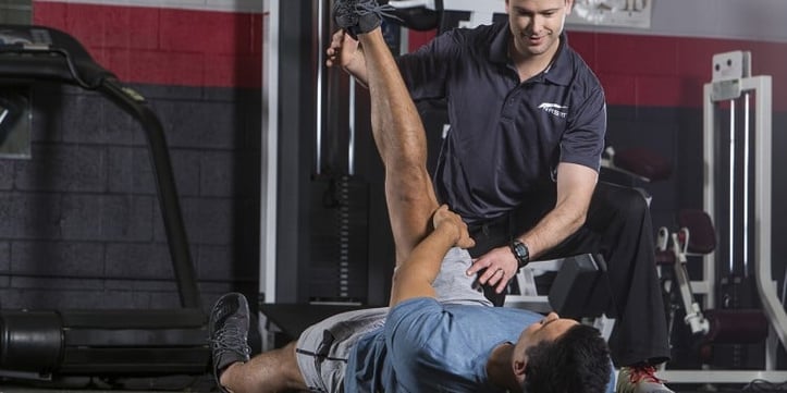 trainer assessing the kinetic chain of a client