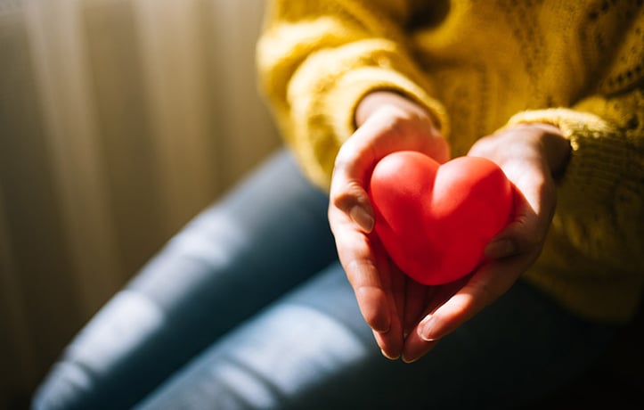 woman holding a foam heart