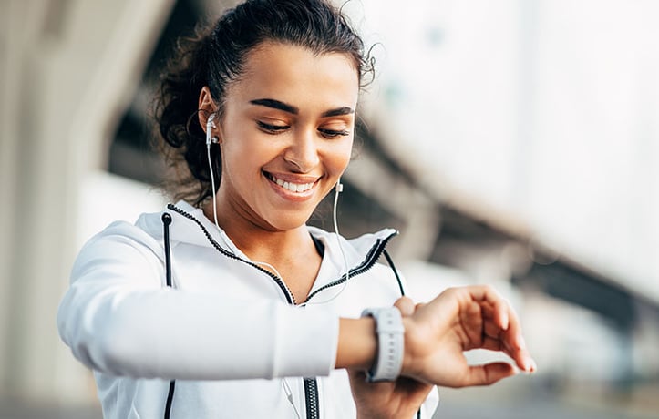 woman checking heart rate on fitness watch