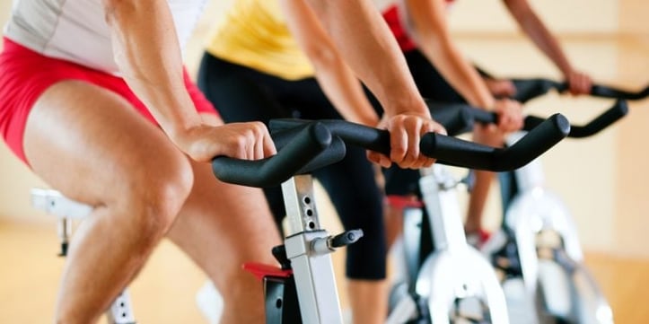 stationary bike riders doing carpal tunnel stretches