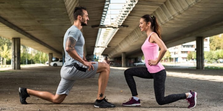 A man and woman doing lunges