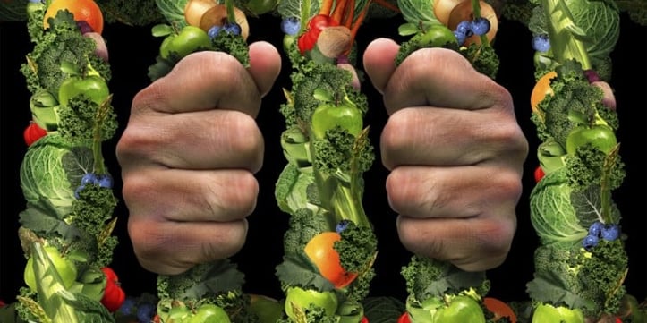 Hands squeezing a variety of vegetables