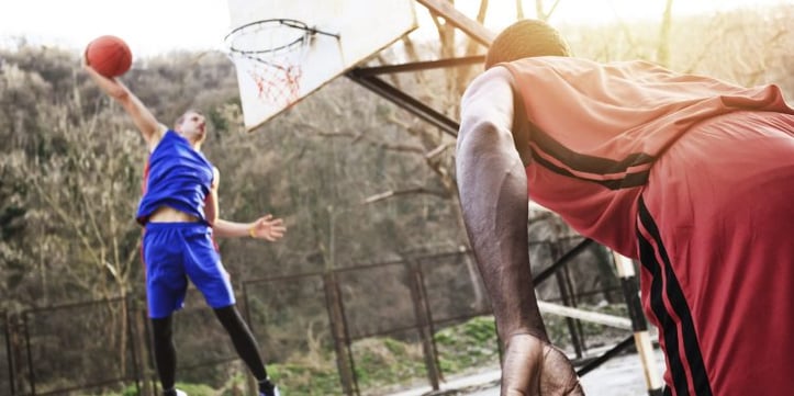 Basketball player dunking ball into hoop