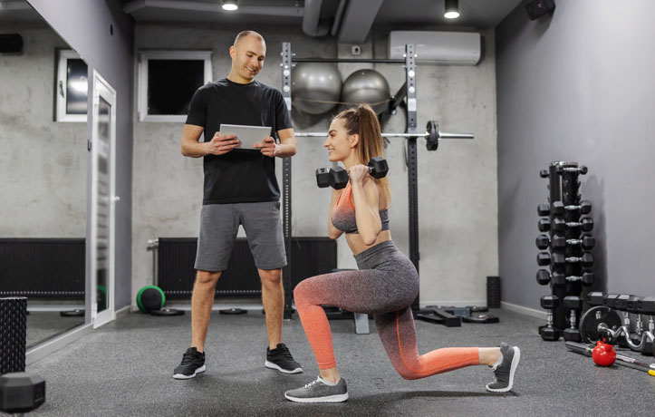 a personal trainer helping a client