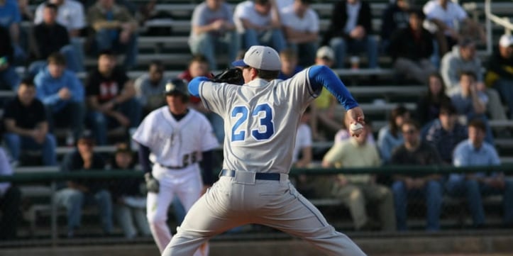 Baseball player with jersey number 23 throwing baseball