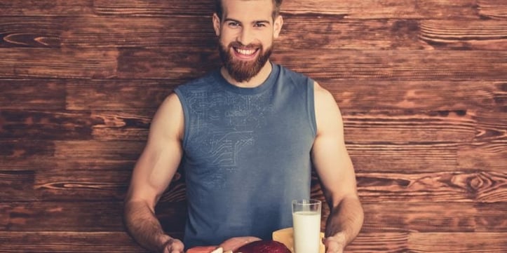 Man holding tray of healthy foods