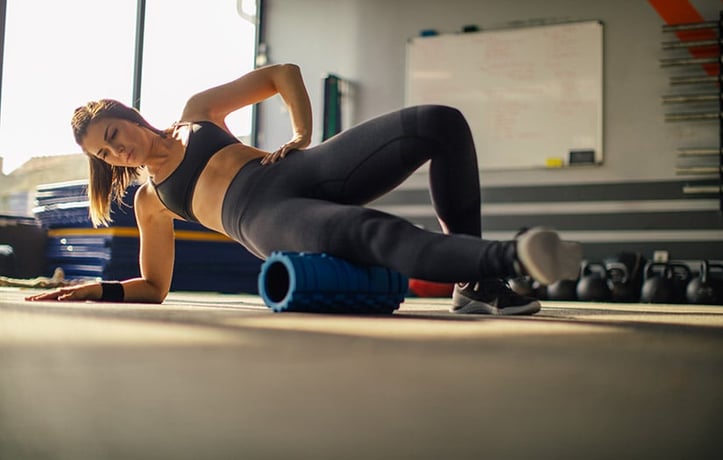 a woman doing phase 1 exercise with foam roller